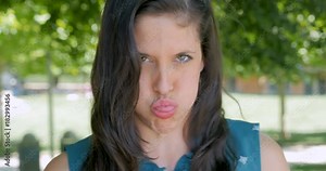 Woman blowing a raspberry showing derision mockery and ridicule