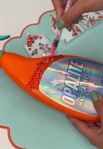 Part 1 of Bedazzling this Opalite spray bottle 💎✨ I created the label design and printed it out using printable holographic sticker paper. This one is definitely going to take me a minute lol but we’re trusting the process over here 👀 Stay tuned for the final reveal!! #rhinestones #bedazzled #swifties #taylorswift #opalite