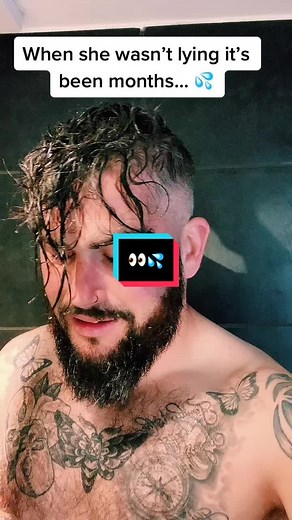 Intricate Tattoo Designs on a Shirtless Individual