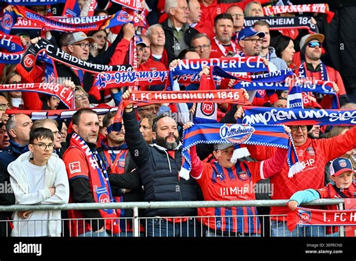 16 May 2026, Baden-Württemberg, Heidenheim: Soccer, Men: Bundesliga, 1. FC Heidenheim - FSV Mainz 05,Matchday 34, Voith-Arena. Fans of 1. FC Heidenheim cheer on their team. Photo: Jan-Philipp Strobel/dpa - IMPORTANT NOTE: In accordance with the regulations of the DFL German Football League and the DFB German Football Association, it is prohibited to utilize or have utilized photographs taken in the stadium and/or of the match in the form of sequential images and/or video-like photo series Stock 