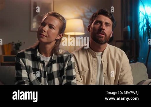 Puzzled Caucasian middle-aged couple family thinking woman coming up with idea happy man husband hugging wife smiling adults spouses think creating success plan joyful hug at couch in evening home Stock Video Footage - Alamy