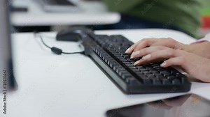 Teacher showing student how to use computer in adult education class