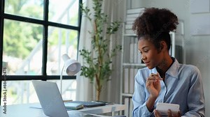 African businesswoman is working on laptop computer doing accounting analysis report, real estate investment data, finance at modern office. Startup business idea.