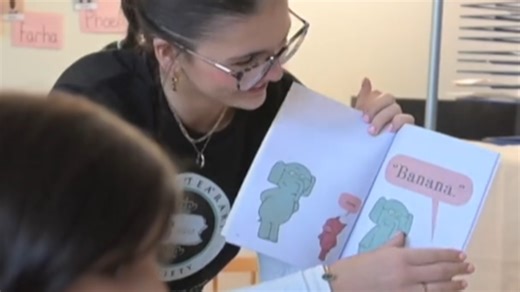 State College Key Club members read and give books to pre-K students