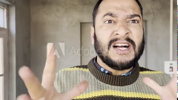 Angry man arguing loudly with other man. Closeup of a man very angry shouting using angry words loudly. Angry dissatisfied man arguing very loudly using harsh words.