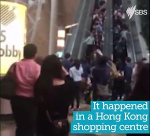 Dramatic footage of the moment a packed escalator suddenly went in reverse | SBS News