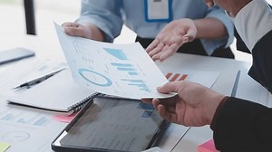 Close up of Business team analyzing income charts and graphs with modern laptop computer. Business analysis and strategy concept.