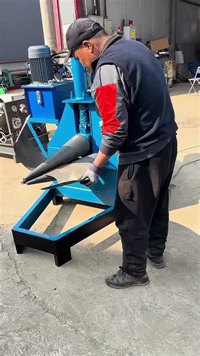 Inserting metal sheet into industrial rolling machine to create curved components for fabrication