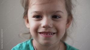 Portrait Funny Happy little kid close up happy preschool girl smiling child looking at camera pretty natural face. sincere emotions ashamed, embarrassed clean skin dermatology, pediatric dentistry