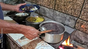 Feijoada cooked in a wood stove with rice and farofa