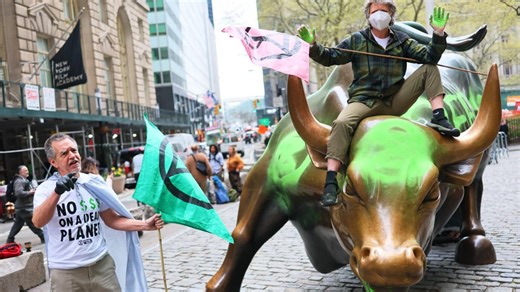 Wall Street’s iconic charging bull statue vandalized by climate activists wielding neon green paint