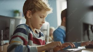 Elementary School Classroom: Smart Boy Uses Personal Computer, Learning How to Use Internet Safely, Programming Language for Software Coding. Schoolchildren Getting Modern Education. Portrait Shot