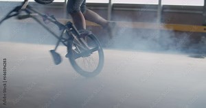 Male rider performing trick on inverted BMX