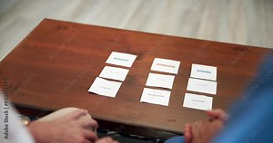 Mental health, therapy and people with memory test for senior care, dementia and mind assessment. Healthcare, elderly person and caregiver with card, puzzle or alzheimer evaluation in nursing home