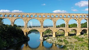 Exploring the majestic Pont du Gard aqueduct in France, discover the stunning architecture of the ancient Pont du Gard aqueduct in southern France. River Gard, Languedoc-Roussillon, France.