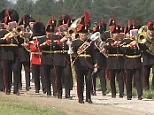 The Royal Artillery marching band proudly greets the Queen