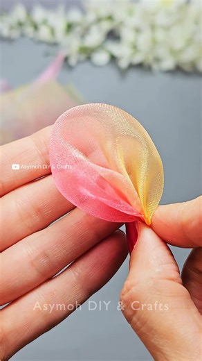 ‎AsiehSafa . آسیه صفا‎ on Instagram: "Folding Fabric Into the Perfect Flower #satisfying #craft #diy In this video, learn how to create beautiful diy flowers using vibrant tulle fabric. This flower making tutorial guides you through each step, from cutting and shaping petals to assembly, making it one of my favorite easy crafts. Discover how simple it is to make a stunning handmade floral piece, perfect for adding a touch of elegance to any project. Learn how to make a colorful chiffon flower us