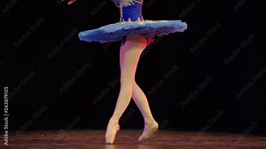 A ballerina dances en pointe on stage during a performance.
