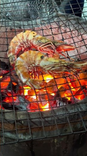 grilling prawn on fire wood