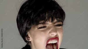 Screaming face close up. Hate and rage. Angry woman screaming. Emotional face. Screaming mouth, emotional young woman screaming. Mad and sad furious shout.