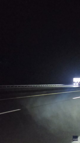 Funnel Cloud Illuminated by Lightning in Eerie Nighttime Scene