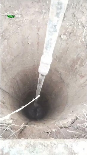 The process of extracting water by digging a well.
