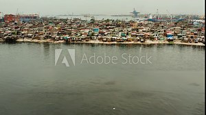 Slums in Manila near the port. Houses of poor inhabitants. A lot of garbage in the water, Philippines, top view.