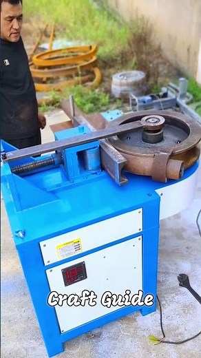 The process of bending a thick metal pipe with a bending machine