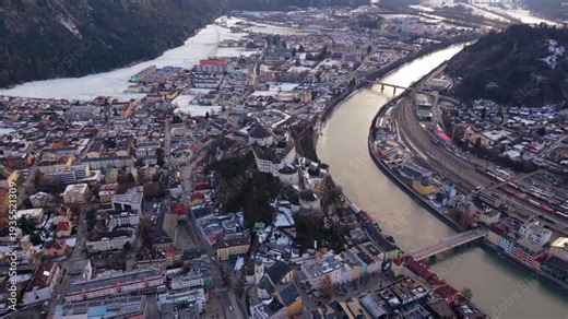 Drone video of Festung Kufstein, Austria. Medieval castle on a hill seen from the air. Luftaufnahme von Kufstein in Tirol. Historic old town and the Inn river valley in winter scenery.