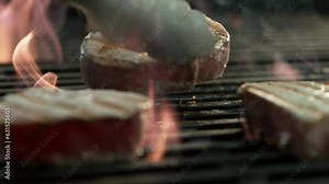 Steak cooking on a grill in slow motion