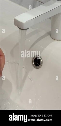 washing his hands thoroughly under running tap water. This attention to hand hygiene emphasizes safety and cleanliness before preparing Stock Video Footage - Alamy