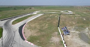 Aerial Footage Of Car Racing Track With Corners Championship Driving Cinematic Look Asphalt Burned Tires Cloudy Day High Speed Cornering