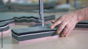 A vertical cutting machine makes incisions.