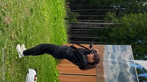 Beautiful young woman photographer holds a camera and taking photo. Adorable brown hair girl is taking pictures of nature with camera