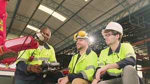 Male production engineers team discuss, test, and controls robotic arm in mechanical manufacturing factory, intelligent automatic machines in industrial business, and futuristic technology innovation.