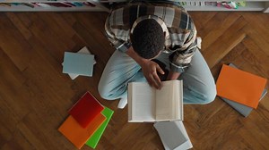 Top view African American man male guy unrecognizable student library bookshop bookshelf read pile books textbooks high school bookworm librarian study exam knowledge research educate learner pupil