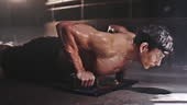 Handsome strong bodybuilder sports man athlete workout push-ups...