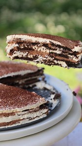 Beat the heat with this no-cook Tiramisu Icebox Cake! Made with chocolate wafer cookies, it’s a make-ahead hit for summer parties. Get the recipe!https://thegiadzy.visitlink.me/3hFwEJ | Giadzy