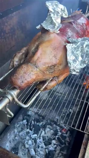 Delicious Pig on a Spit Cooking Over Charcoal