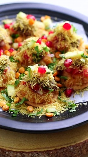 Sev Puri or Sev Batata Puri A popular Mumbai street food that now be made in the comfort of your home! These bite-sized appetizers are bursting with flavor and texture and perfect for parties!! You can prep everything in advance and assemble just before serving and see the plates go empty in seconds. Full recipe on www.shwetainthekitchen.com #sevpuri #chaat #partyfood #partyfoodideas #newyearparty #easyrecipes #indianfood #vegan #mumbaistreetfood #streetfood