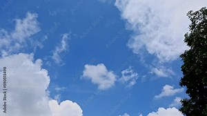 Relaxing view of white clouds moving slowly in the blue sky at daytime