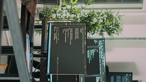 Vertical video: African american team of cloud programers talking about programming compiling code, working on new user interface development. Coders doing teamwork to develop server algorithms.