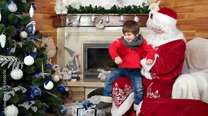 santa welcomes little boy, kid getting christmas present sitting on santa claus lap, presents for good and obedient children, holiday atmosphere, child visiting saint nicolas winter residence, x-mas