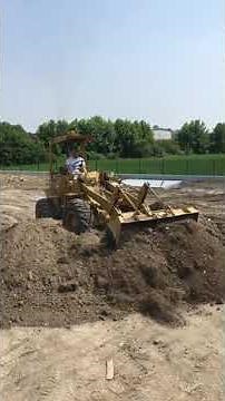 CAT 910 Wheel Loader Pushing Topsoil