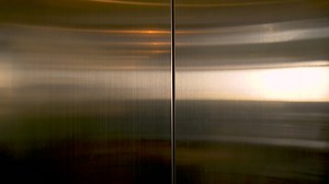 Woman exits an elevator - Free Stock Video