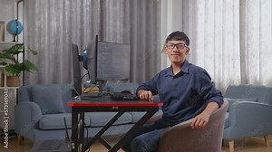Asian Boy Programmer Smiling To Camera While Creating Software Engineer Developing App, Program, Video Game On Desktop Computer At Home. Terminal With Coding Language