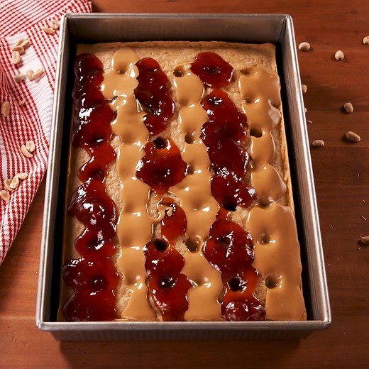 This PB & J Poke Cake is your favorite childhood snack in dessert form. Full recipe: http://dlsh.it/Oi6zALO | Delish