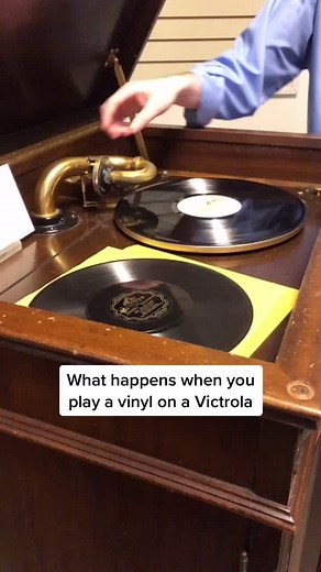 Playing a Vinyl on a Victrola: A Vintage Collection Experience