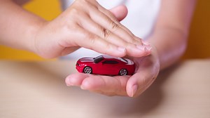 Hand woman protect with her hands a red car, concept for insurance, buying, renting, fuel or service and repair costs | Premium Stock Video Footage