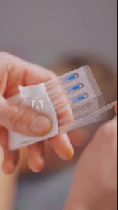 Close-up, acupuncture needles in doctor's hand. Acupuncture. In the spa, a worker takes out needles for an acupuncture procedure. Vertical video.